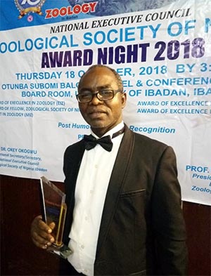 Prof. A.O. Lawal Displaying the Plaque
